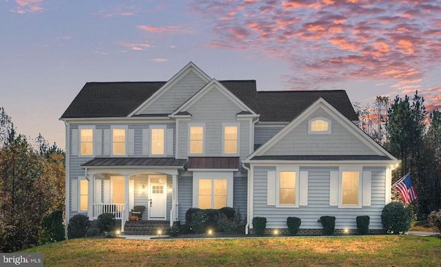 view of front facade featuring a lawn and a porch