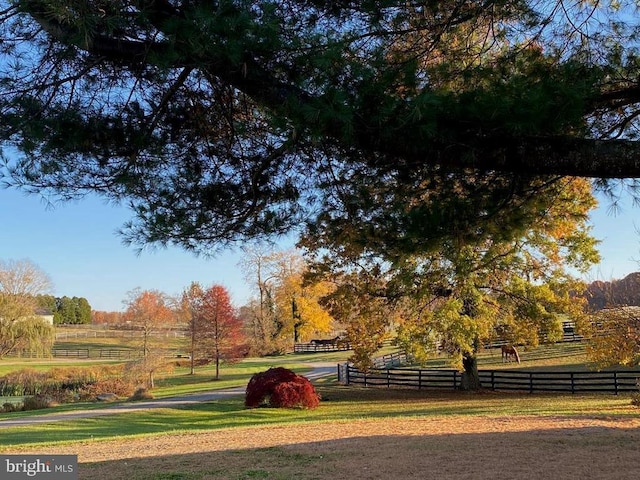 view of home's community with a yard and a rural view