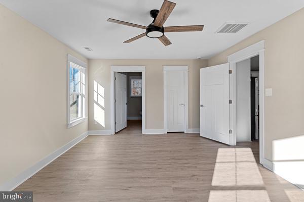 interior space with ceiling fan and light hardwood / wood-style floors