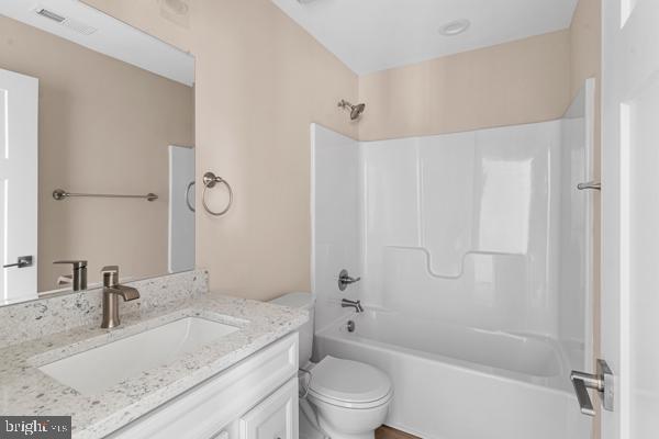 full bathroom with vanity, toilet, and washtub / shower combination