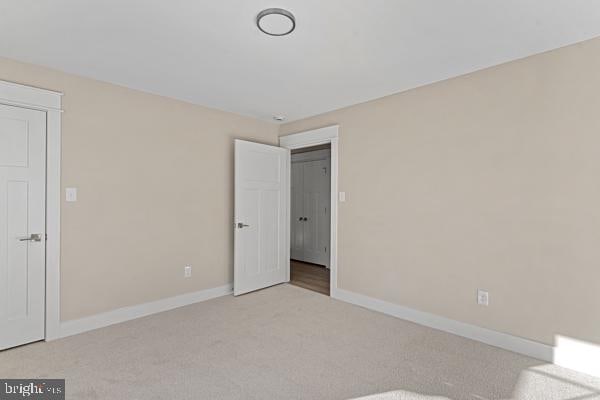 unfurnished bedroom with light colored carpet