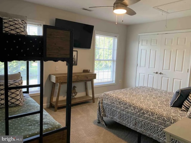 bedroom with carpet flooring, a closet, and ceiling fan