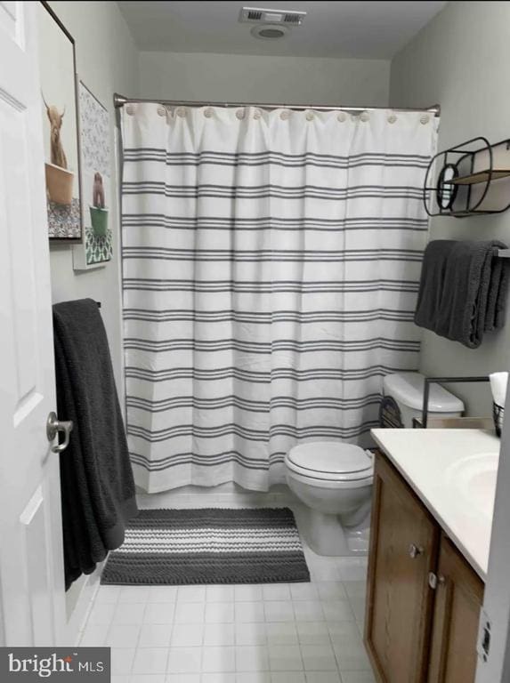 bathroom with vanity, toilet, tile patterned flooring, and a shower with shower curtain