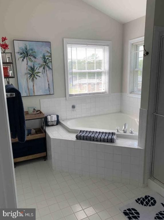 bathroom with plus walk in shower, tile patterned floors, and vaulted ceiling