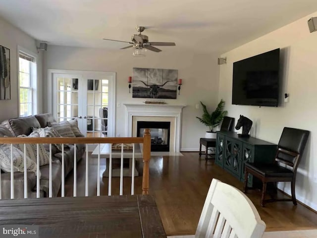 living room featuring ceiling fan and dark hardwood / wood-style flooring