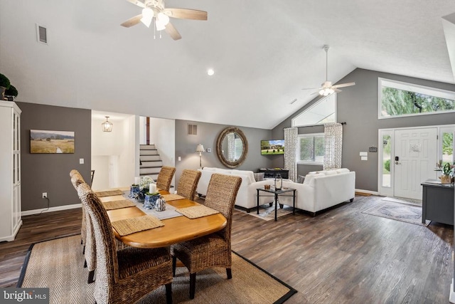 dining space with ceiling fan, high vaulted ceiling, and dark hardwood / wood-style floors