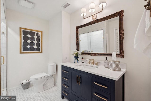 bathroom with vanity, a shower with shower door, toilet, and tile patterned floors