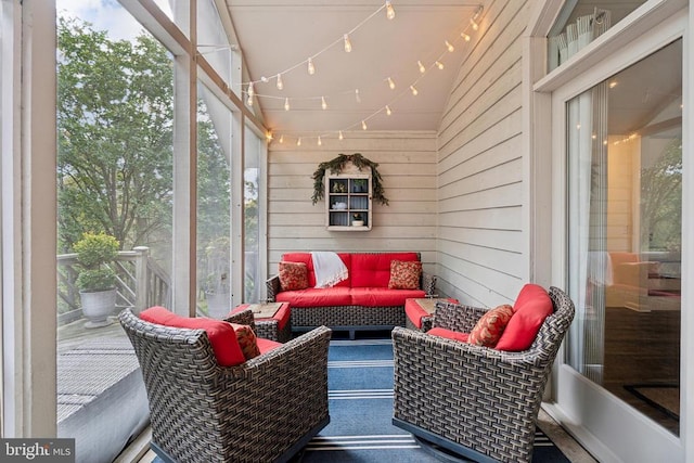 sunroom / solarium featuring vaulted ceiling and a wealth of natural light