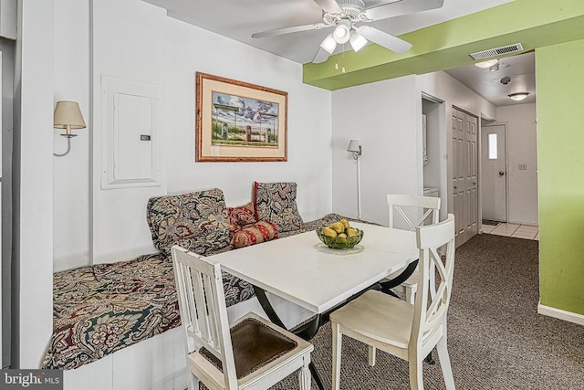 dining space featuring electric panel, carpet flooring, and ceiling fan