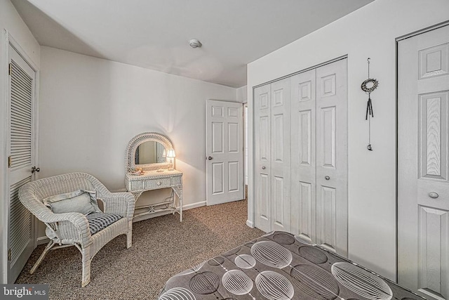 sitting room featuring dark carpet