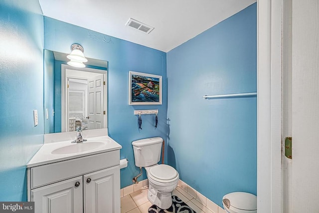 bathroom featuring vanity, toilet, and tile patterned floors