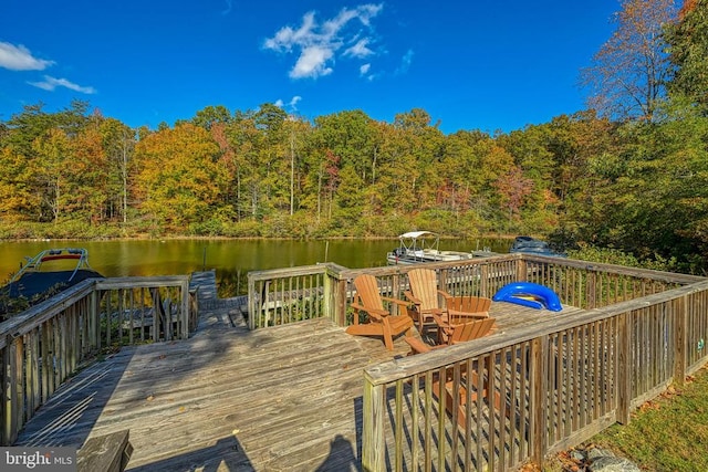 wooden terrace featuring a water view and a boat dock