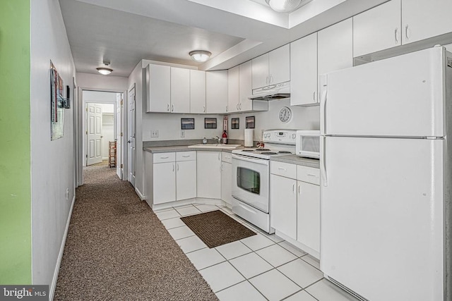 kitchen featuring white cabinets, sink, light tile patterned floors, and white appliances