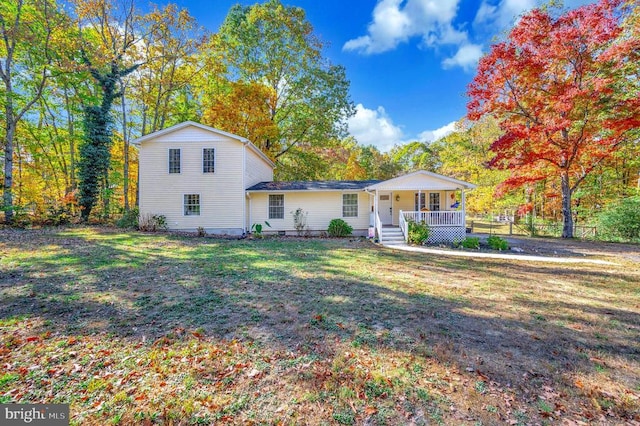 view of front of house featuring covered porch and a front lawn