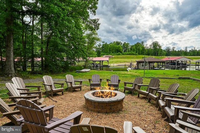 view of patio / terrace featuring a water view and a fire pit