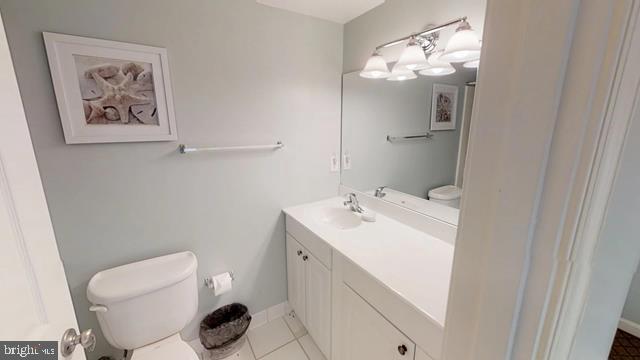 bathroom featuring vanity, toilet, and tile patterned flooring