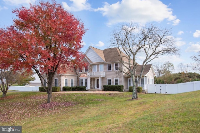 view of front of property with a front lawn and a balcony