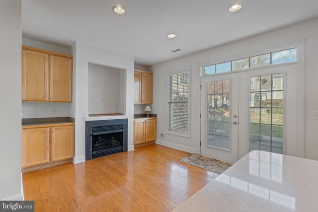 unfurnished living room with light hardwood / wood-style flooring