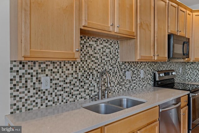 kitchen featuring light brown cabinets, stainless steel appliances, tasteful backsplash, and sink