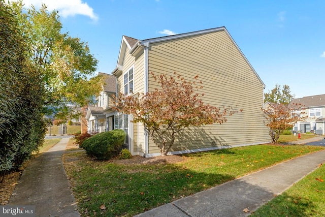 view of home's exterior with a yard