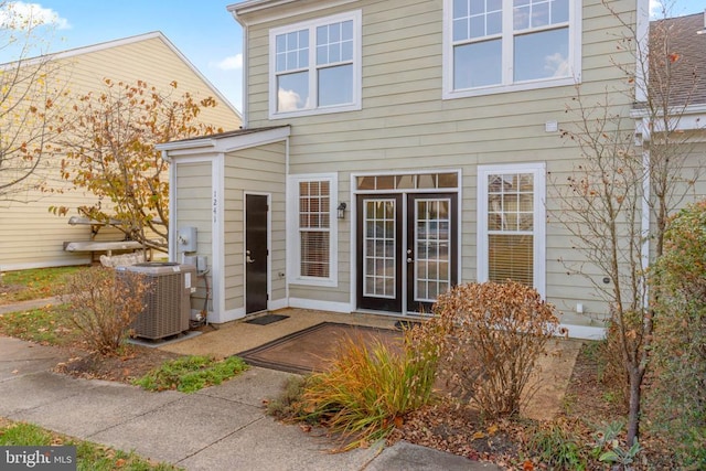 rear view of house with french doors and cooling unit