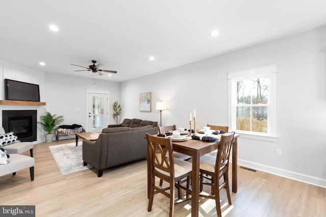 dining area with ceiling fan and light hardwood / wood-style flooring