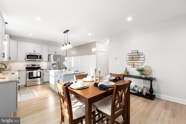 dining area featuring light hardwood / wood-style flooring and sink