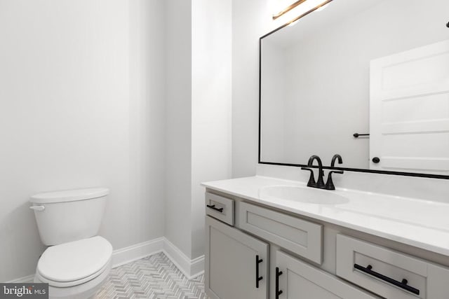 bathroom with tile patterned floors, vanity, and toilet