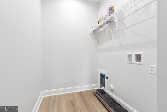 washroom featuring electric dryer hookup, hookup for a washing machine, and hardwood / wood-style floors