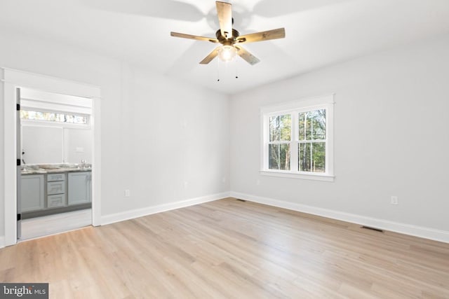 spare room featuring light hardwood / wood-style flooring and ceiling fan