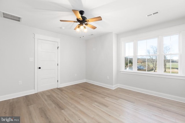 empty room featuring ceiling fan and light hardwood / wood-style flooring