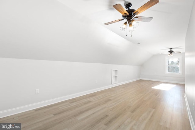 additional living space with light hardwood / wood-style floors, built in features, ceiling fan, and lofted ceiling