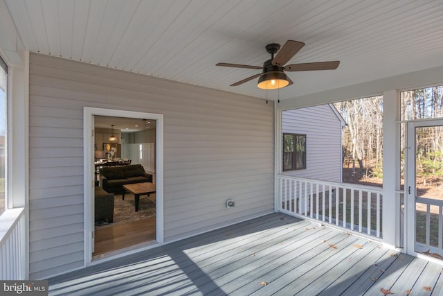 wooden terrace featuring ceiling fan