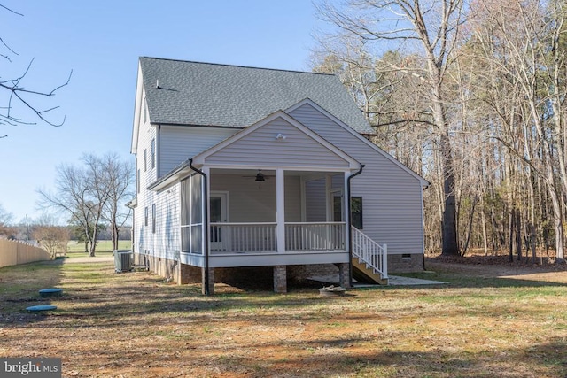 bungalow featuring a sunroom, cooling unit, and a front yard