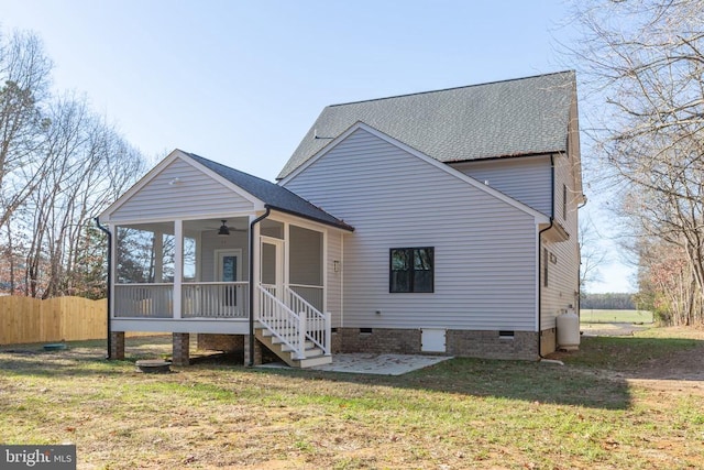 exterior space with ceiling fan, a patio, a front lawn, and a sunroom