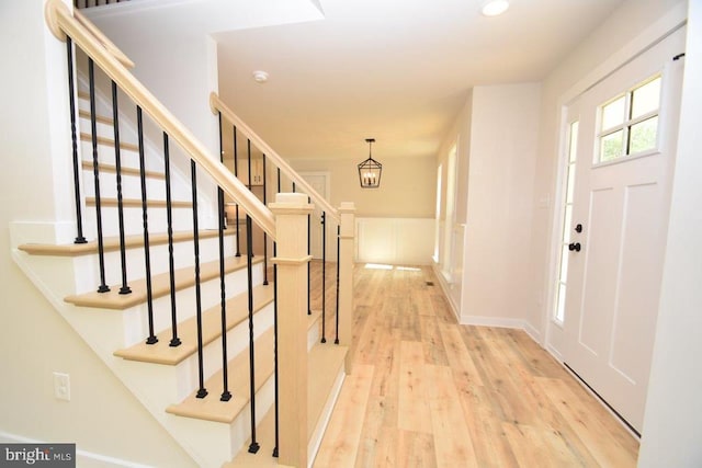 entrance foyer featuring an inviting chandelier and light wood-type flooring