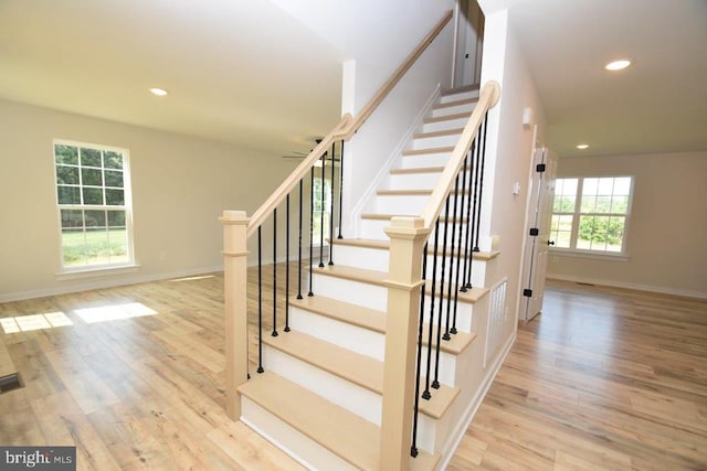 stairway with hardwood / wood-style flooring