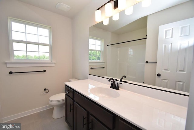 bathroom featuring vanity, a shower, and toilet