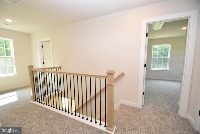 hallway with light colored carpet