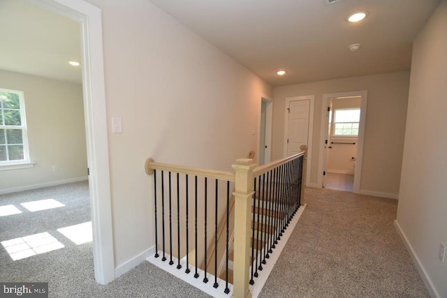 corridor featuring light colored carpet