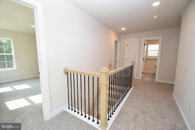 corridor featuring light colored carpet