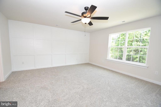 empty room with ceiling fan and carpet