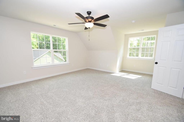 bonus room featuring lofted ceiling, carpet, a healthy amount of sunlight, and ceiling fan