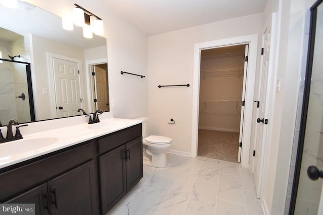 bathroom featuring vanity, toilet, and an enclosed shower