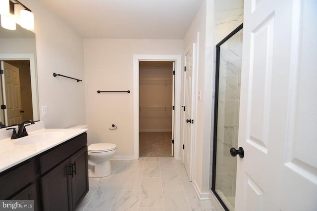 bathroom with vanity, a shower with shower door, and toilet