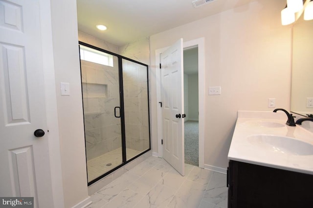 bathroom featuring vanity and a shower with shower door