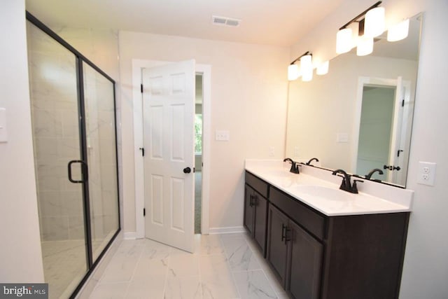 bathroom with vanity and a shower with door