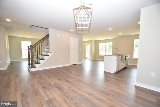 unfurnished living room featuring dark hardwood / wood-style floors and a chandelier