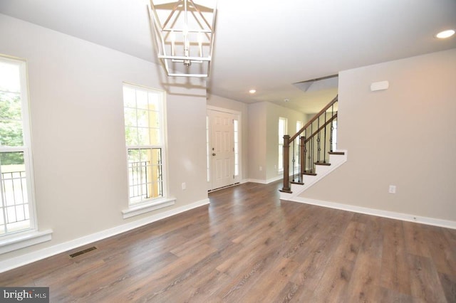 entryway featuring a notable chandelier and dark hardwood / wood-style flooring