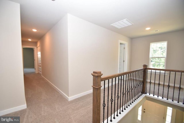 hallway with light carpet